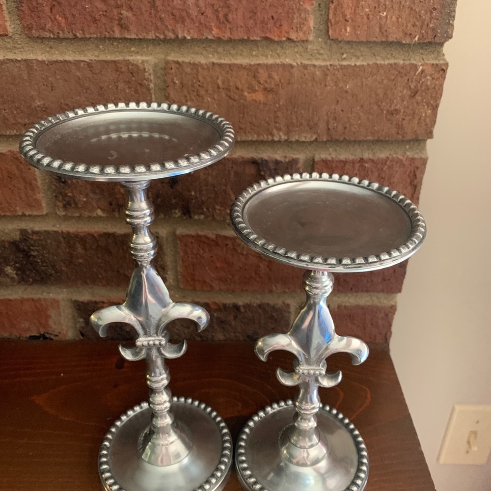 Two silver fleur de lis candle holders